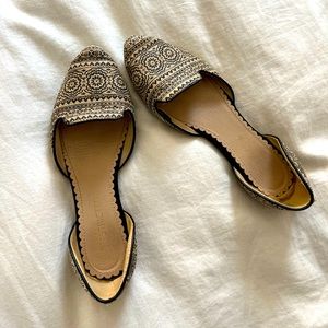 Flats with patterned canvas material at toe and heel.